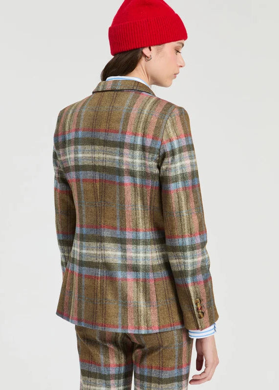 Person wearing a plaid suit and red beanie on a plain background