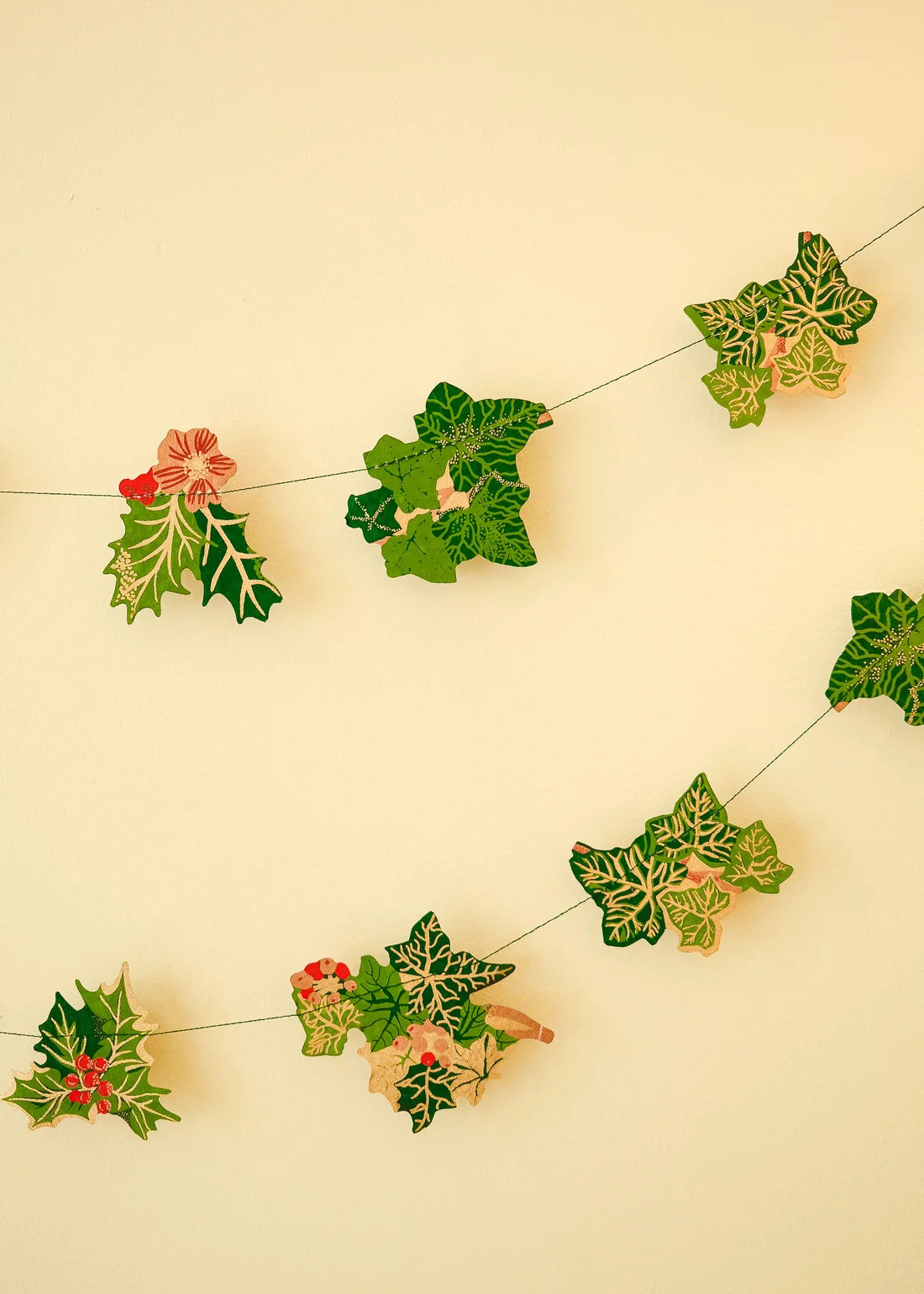 Decorative holly leaf garland on a beige background
