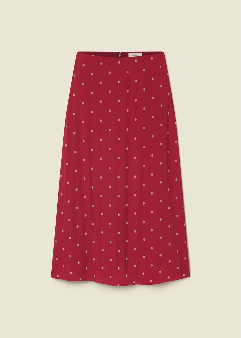 A red A-line skirt with a small white polka dot pattern, shown flat against a light beige background.