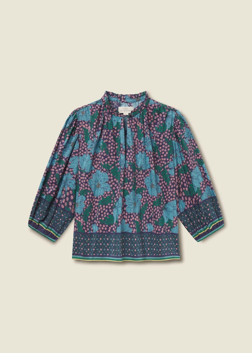 Long-sleeve top with floral pattern on a beige background