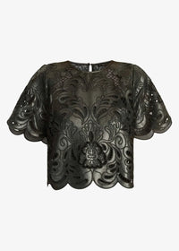 A black sheer mesh top with intricate floral lace applique and a central lion head motif, featuring short puff sleeves and a scalloped hem, shown against a light gray background.