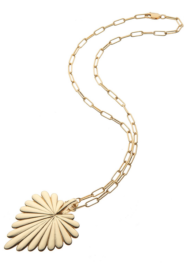 A gold pendant necklace featuring a fan-shaped, sunburst-style pendant with a textured radial design, suspended from a paperclip-style chain on a plain white background.