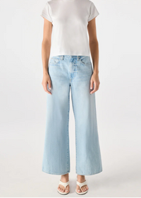 Person wearing a white t-shirt and light blue jeans on a white background