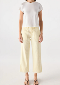 Person wearing a white top and light yellow pants on a white background