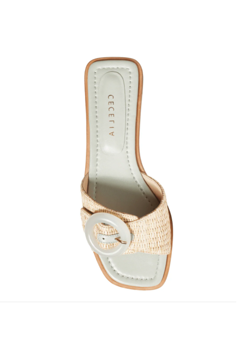 Beige sandal with a circular buckle on a white background