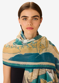 Woman wearing a patterned scarf on a white background