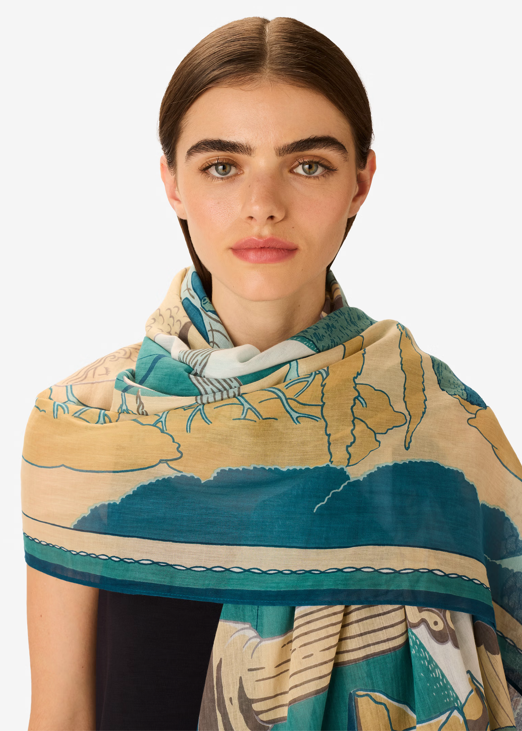 Woman wearing a patterned scarf on a white background