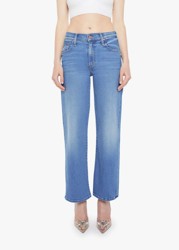 Person wearing blue jeans on a white background