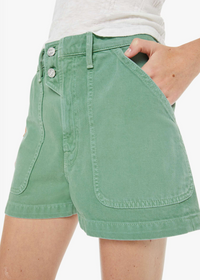 Green shorts worn by a person on a white background