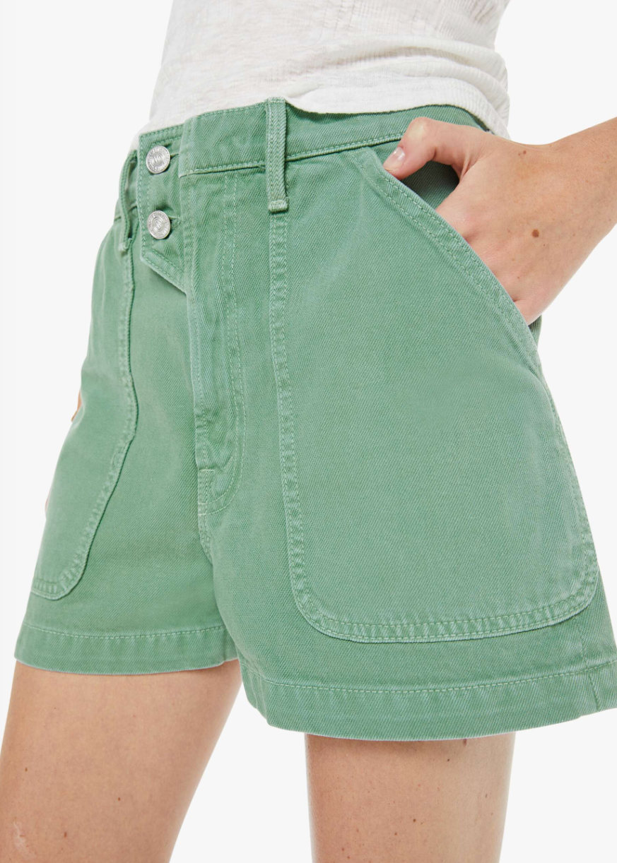 Green shorts worn by a person on a white background