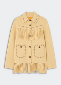 A pale yellow knit cardigan sweater with fringe details, button closures, and decorative stitching, shown against a light gray background.