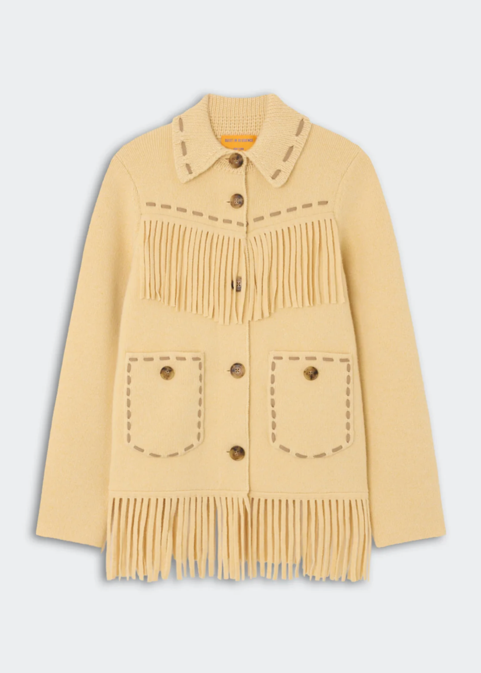 A pale yellow knit cardigan sweater with fringe details, button closures, and decorative stitching, shown against a light gray background.