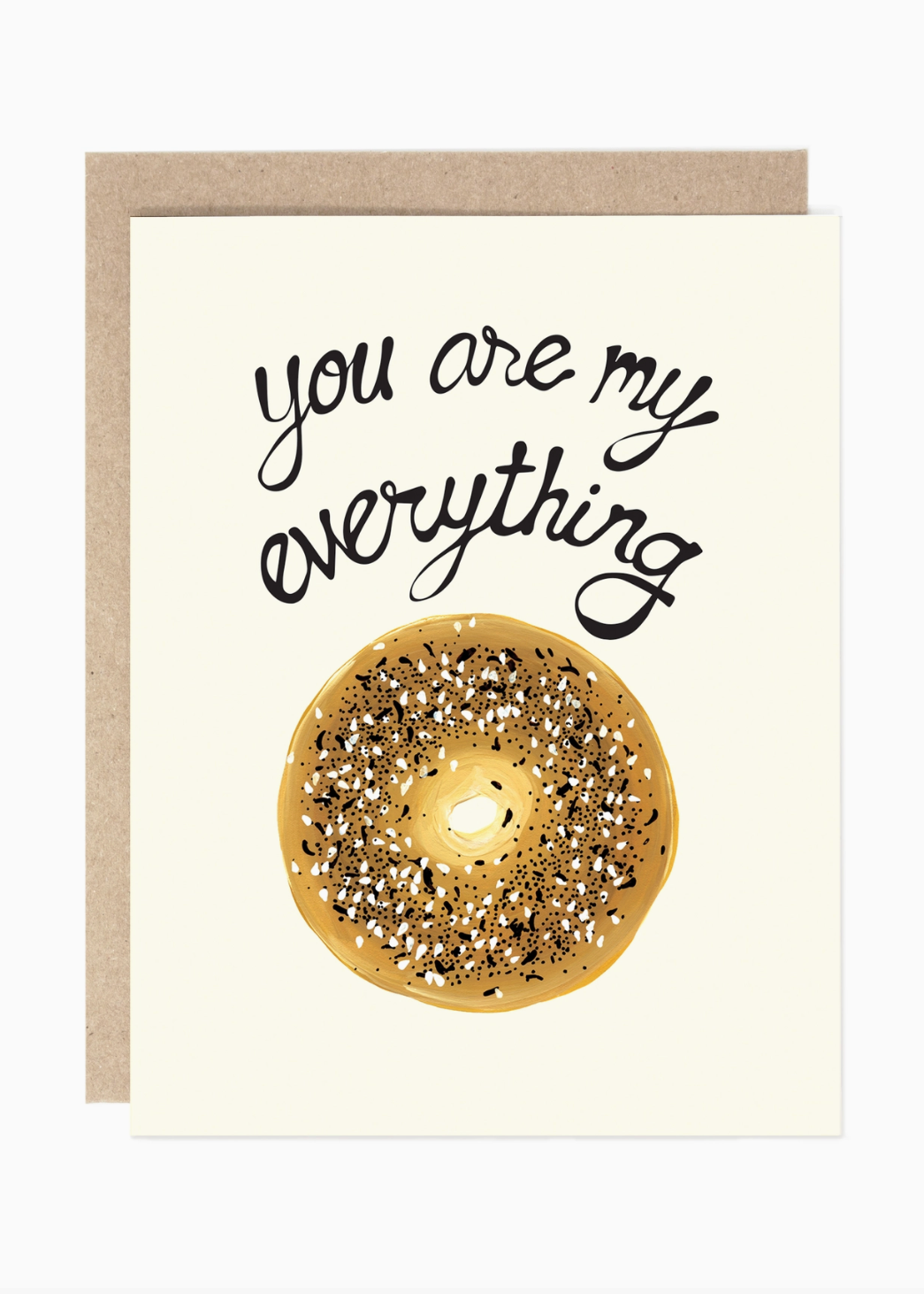 A greeting card with a kraft envelope, featuring the phrase 'you are my everything' in black script above a watercolor-style glazed donut with sprinkles on an off-white card background.