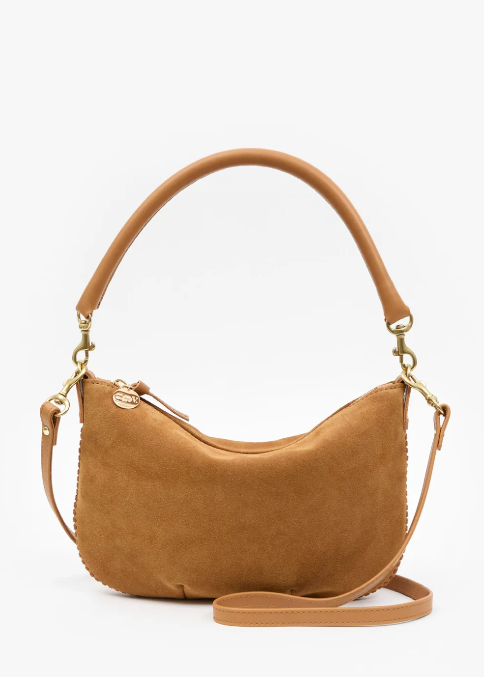 A camel brown suede crescent-shaped shoulder bag with a matching adjustable shoulder strap and gold-tone hardware, photographed on a clean white background.