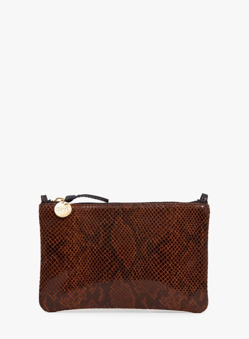 A brown snakeskin-patterned zip pouch with a small gold-tone circular charm on the zipper, photographed against a plain white background.
