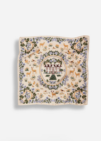 A square scarf with a detailed woodland illustration pattern, featuring deer, trees, birds, and a central circular emblem, displayed flat against a light gray background.