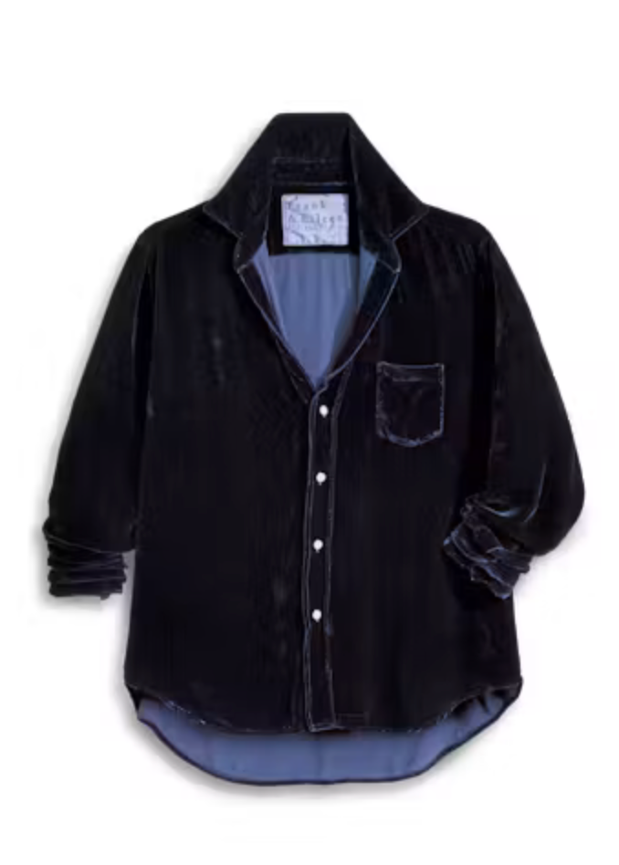 A black corduroy button-up shirt with a blue-gray lining, featuring a chest pocket and rolled cuffs, shown against a plain white background.