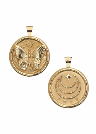 A pair of gold circular pendant necklaces shown on a plain white background. One pendant features an embossed butterfly design, while the other features a crescent moon and star motif with the word 'FREE' at the bottom.
