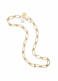 A gold chain necklace with elongated links, a lobster clasp, a small round charm, and a white pearl bead, displayed on a solid white background.