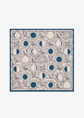 A square scarf featuring a celestial pattern of moon phases, suns, and faces in blue and cream on a white background, framed by a solid blue border.