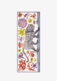 A vertical rectangular scarf featuring a black-and-white striped tiger climbing a blue-gray tree trunk, surrounded by colorful illustrated flowers in red, purple, yellow, and green on a cream background.