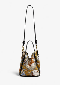 A small top-handle handbag with a long shoulder strap, featuring a vintage-style printed design in gold, beige, and brown tones with black leather trim and gold-tone hardware, shown against a plain white background.