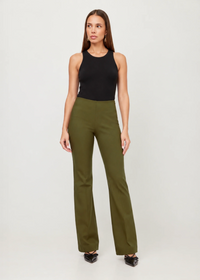 A woman modeling a black sleeveless ribbed tank top and olive green wide-leg trousers against a light gray studio background.