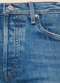 Close-up of blue denim jeans showing the waistband, belt loops, front pocket, and stitching details.