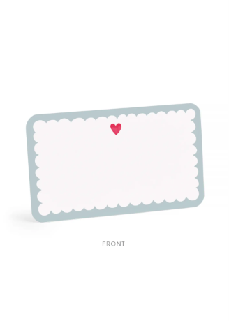 A scalloped rectangular card or label with a pale blue border, white center, and a small pink heart near the top, shown on a light gray background with the word FRONT below.