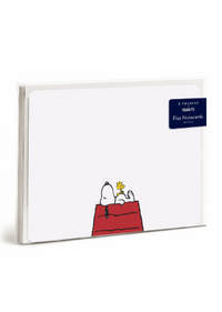 A pack of Peanuts flat note cards on a clean white background. The cards feature a white cardstock base with a classic illustration of Snoopy and Woodstock on a red dog bed at the bottom.