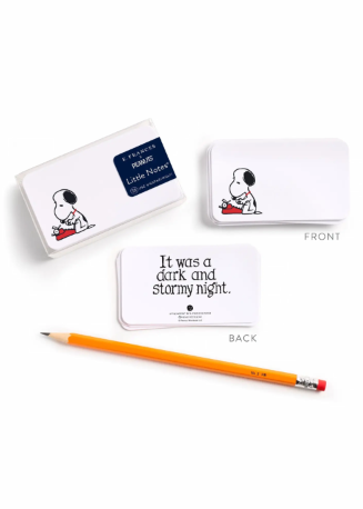 A set of Snoopy-themed Little Notes shown on a white background, including a box labeled 'Snoopy Memory' with a blue label, a front view of the box with Snoopy artwork, a back view with the quote 'It was a dark and stormy night.', and an orange pencil.