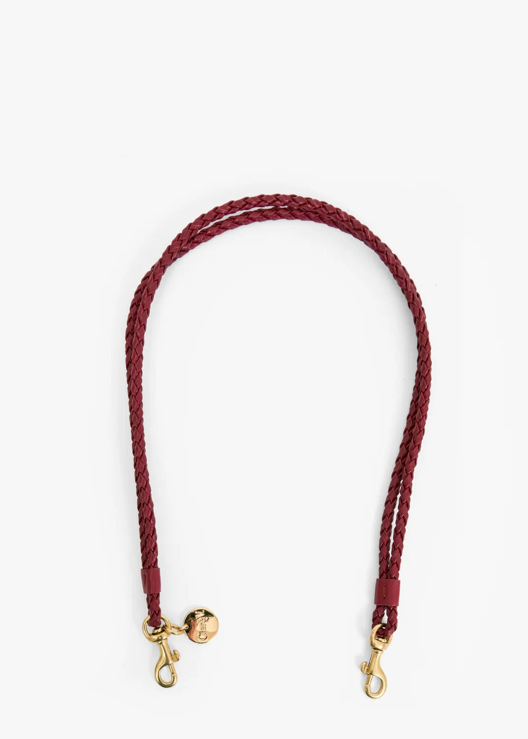 A braided leather shoulder strap in burgundy with gold-tone hardware, including a small decorative charm and two snap hooks, shown on a plain white background.