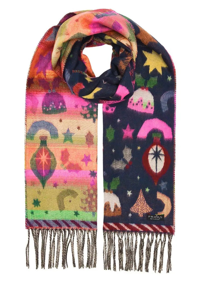 A multicolor patterned scarf with fringe, featuring whimsical illustrations of stars, moons, rainbows, and decorative shapes on a white marble background.